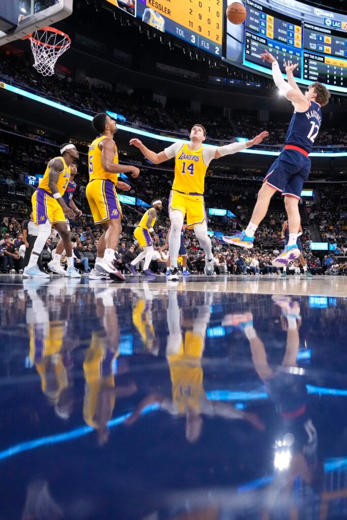 Clippers forward Nick Martinelli, right, shoots as Lakers forward Jarred...