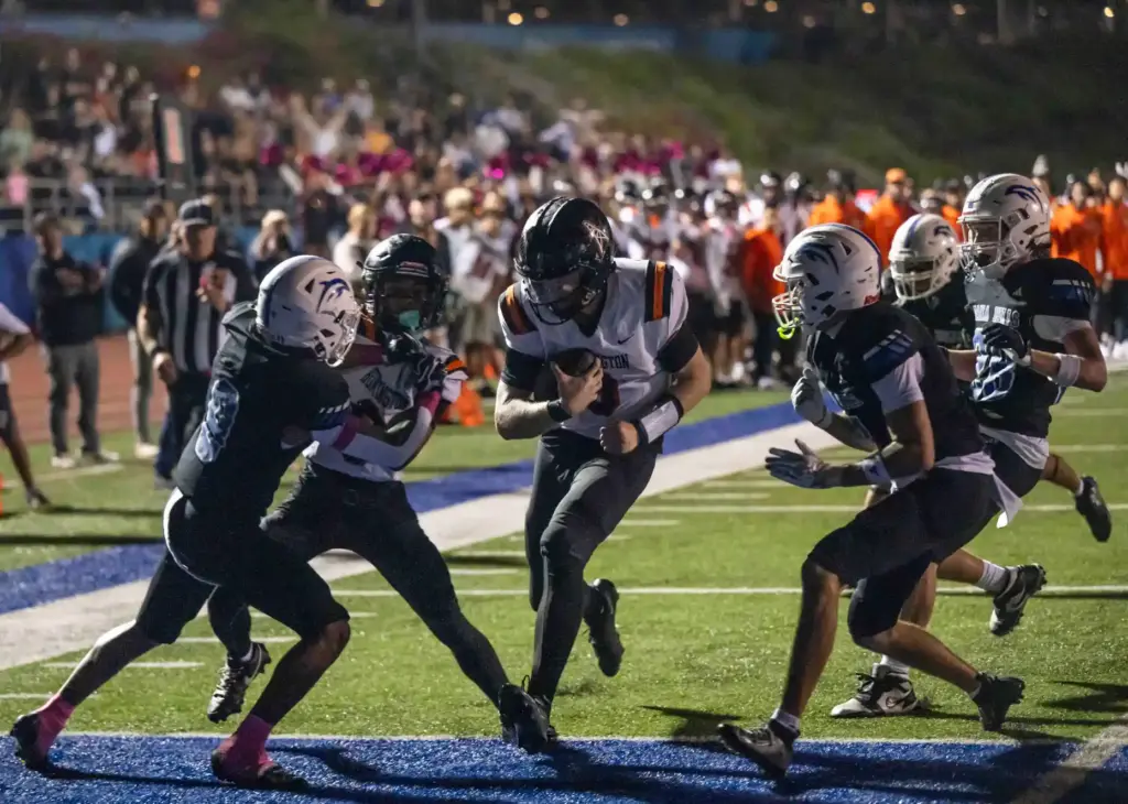 Huntington Beach quarterback Brady Edmunds (9) carries the ball for...