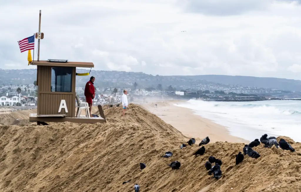 A sand berm reaches the floor of a lifeguard tower...