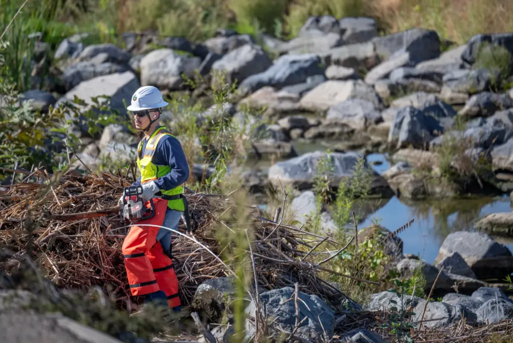 Workers clear the San Juan and Trabuco Creek flood control...