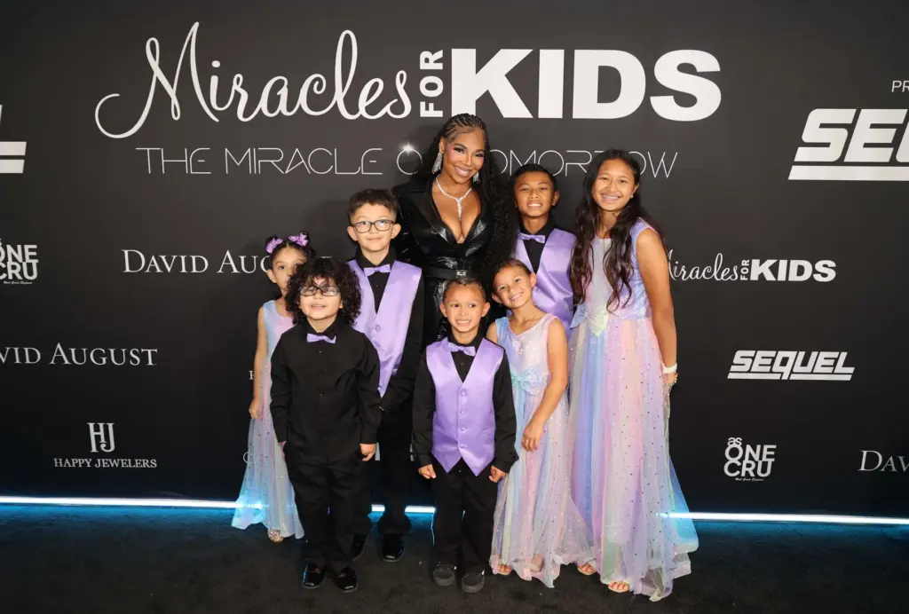 Singer and actress Ashanti poses with Miracles for Kids children...