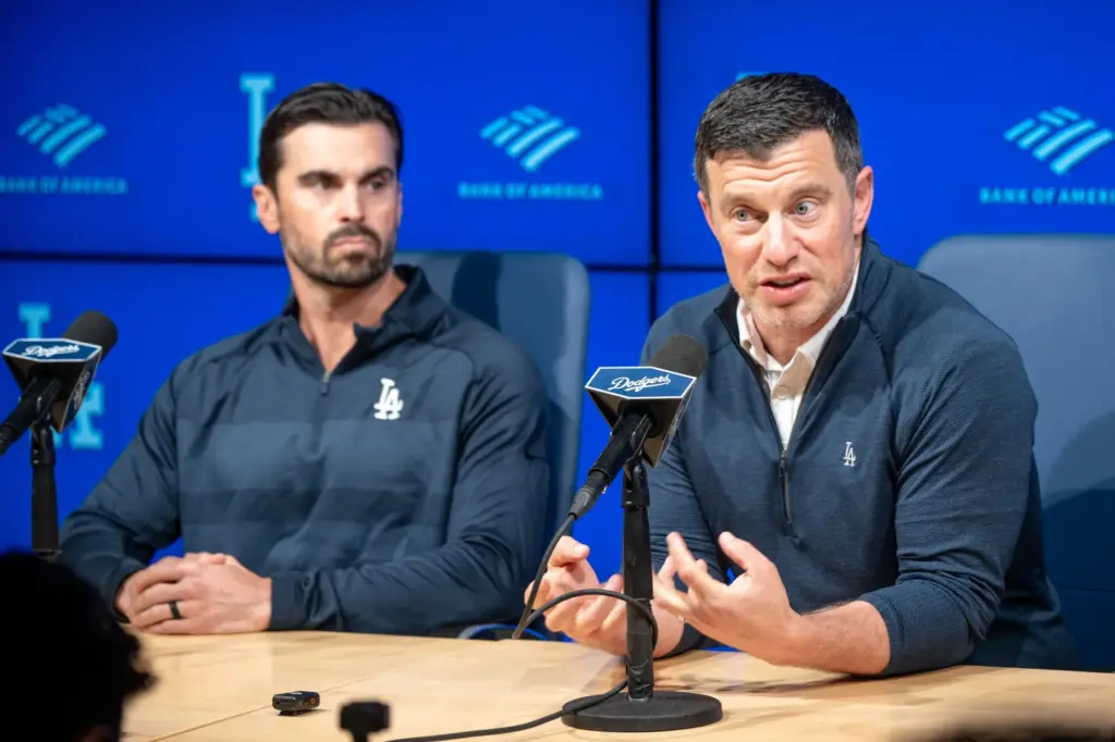 Dodgers president of baseball operations Andrew Friedman, right, speaks to...