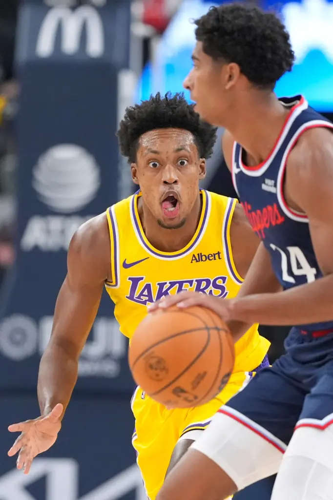 Clippers guard Cam Christie, right, handles the ball as Lakers...
