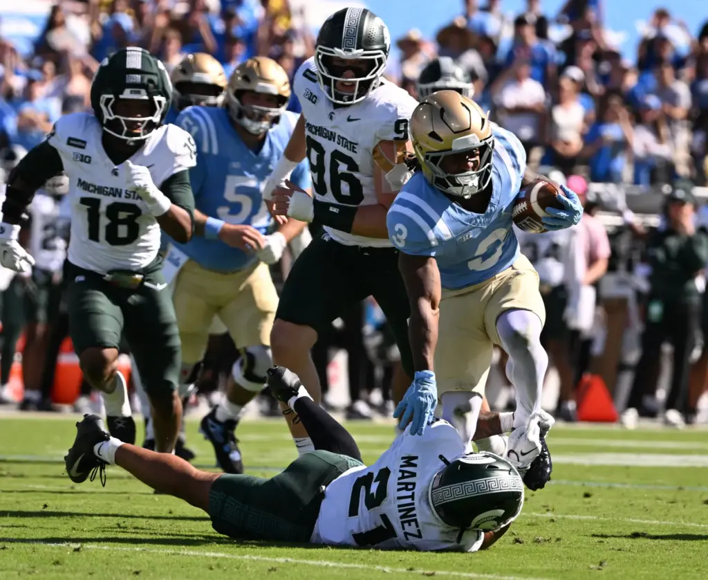 UCLA running back Wayne Knight (3) runs over Michigan State...
