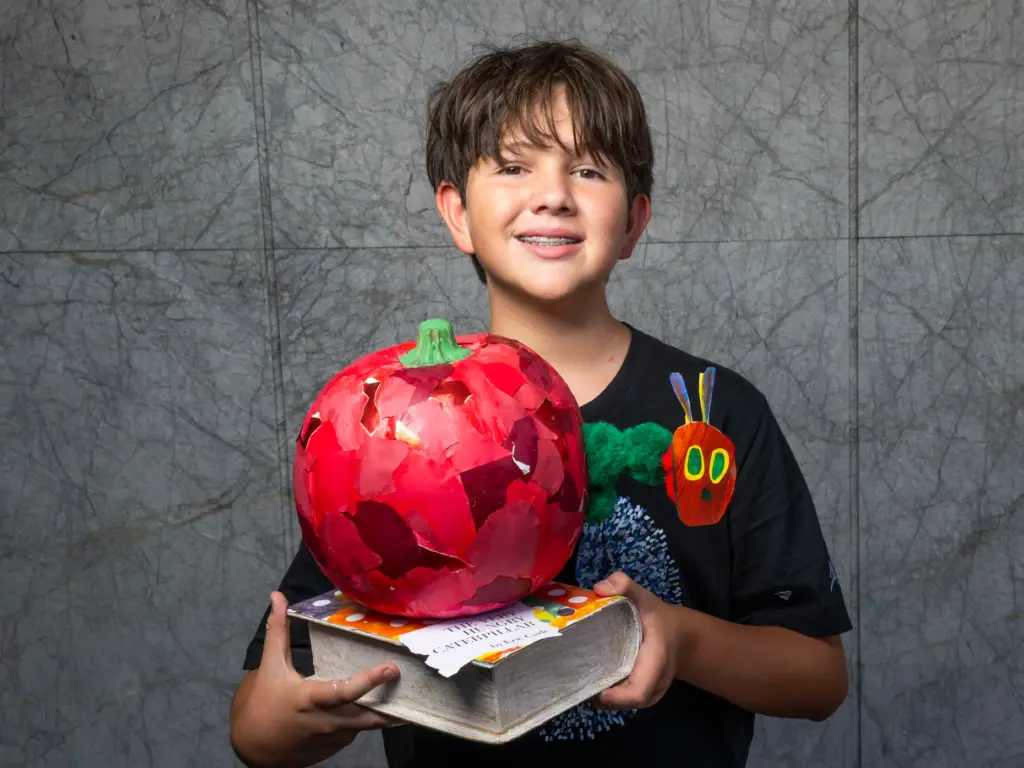Josh Maya holds his pumpkin titled âVery Hungry Caterpillarâ which...