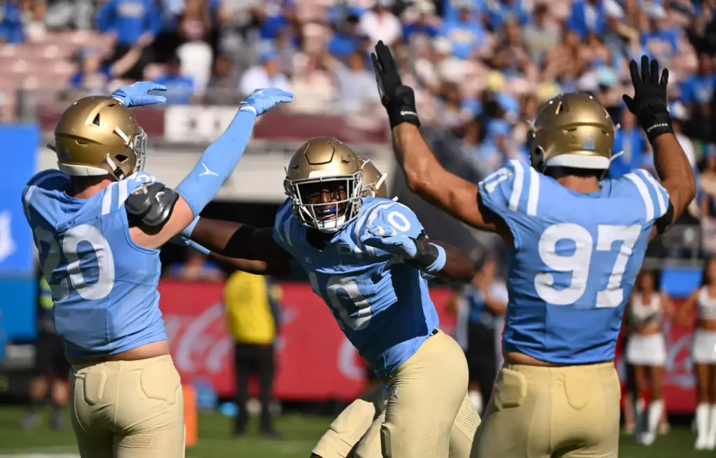 UCLA linebacker Sammy Omosigho (10) celebrates after sacking Michigan State...