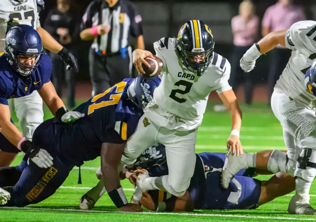 Capistrano Valley quarterback Talon Spencer falls forward for a first...