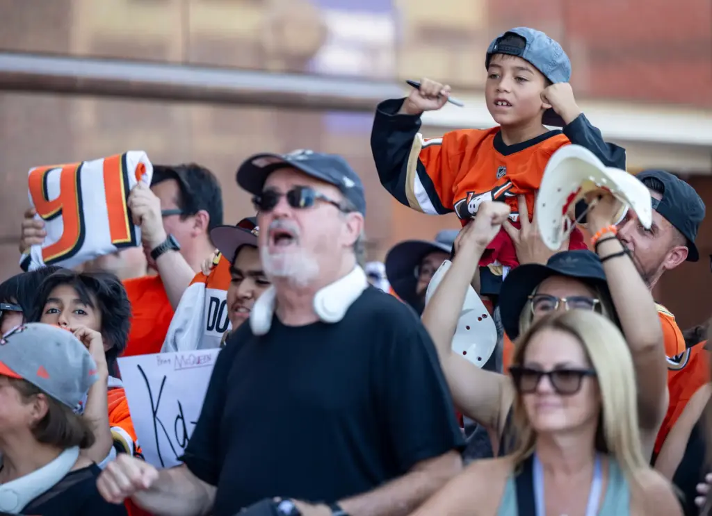 Ducks fans cheer as players arrive on the orange carpet...