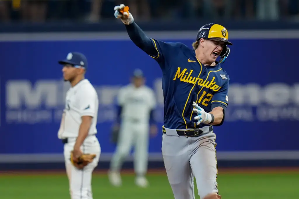 The Milwaukee Brewers’ Cooper Pratt celebrates as he runs the...