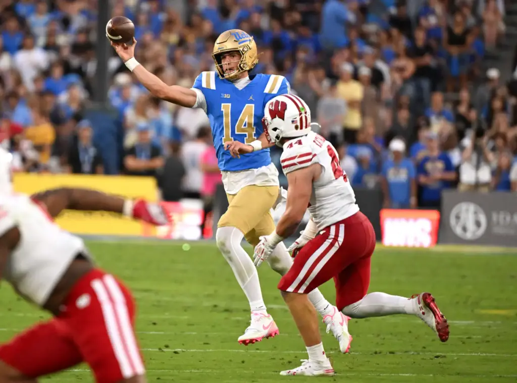 Quarterback Ty Dieffenbach #14 of the UCLA Bruins passes over...