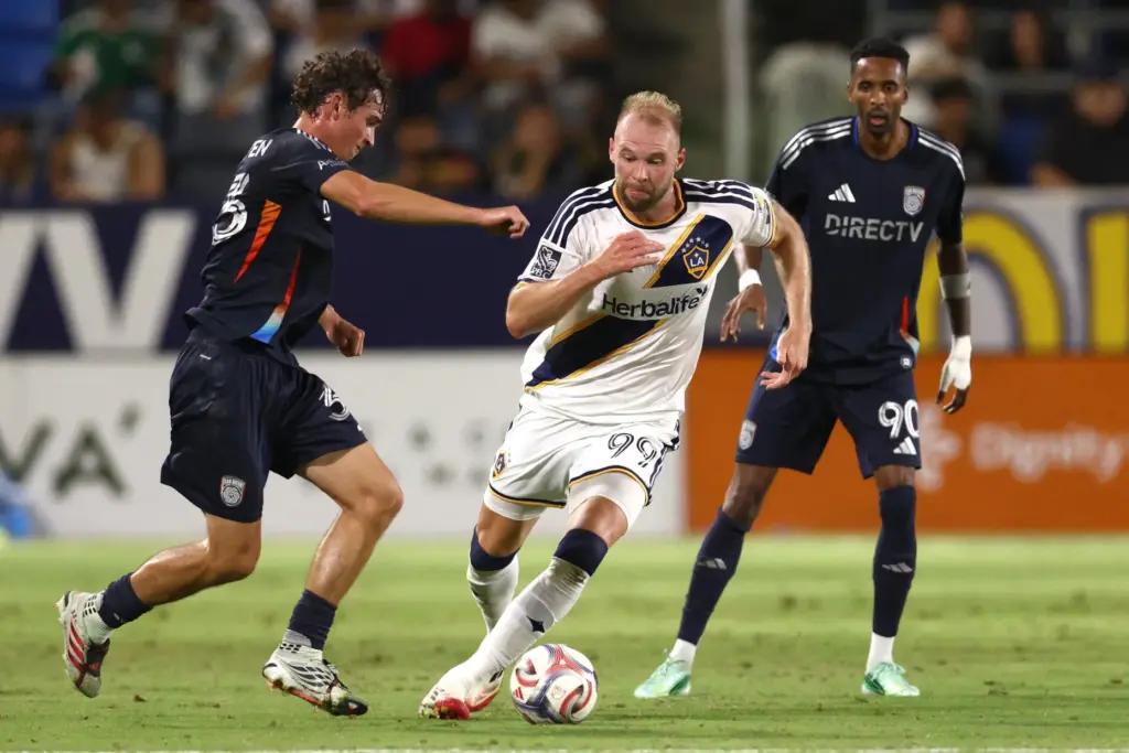 Los Angeles Galaxy forward JoÃ£o Klauss, center, chases the ball...