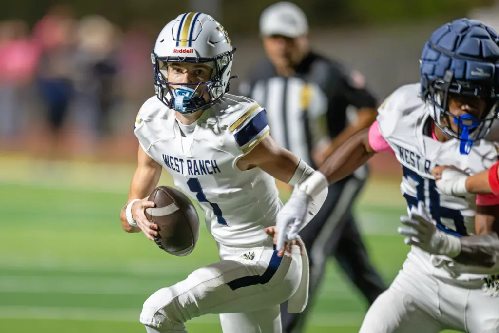 West Ranch High School’s Matthew Steen (1) carries the ball...