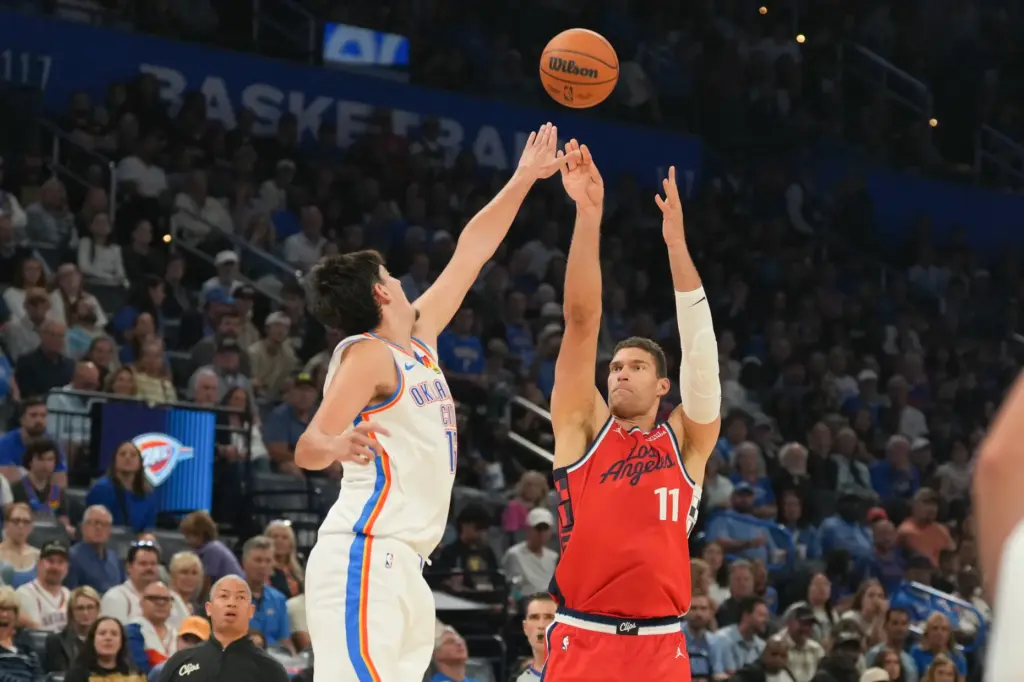 Clippers center Brook Lopez, right, shoots over Oklahoma City Thunder...