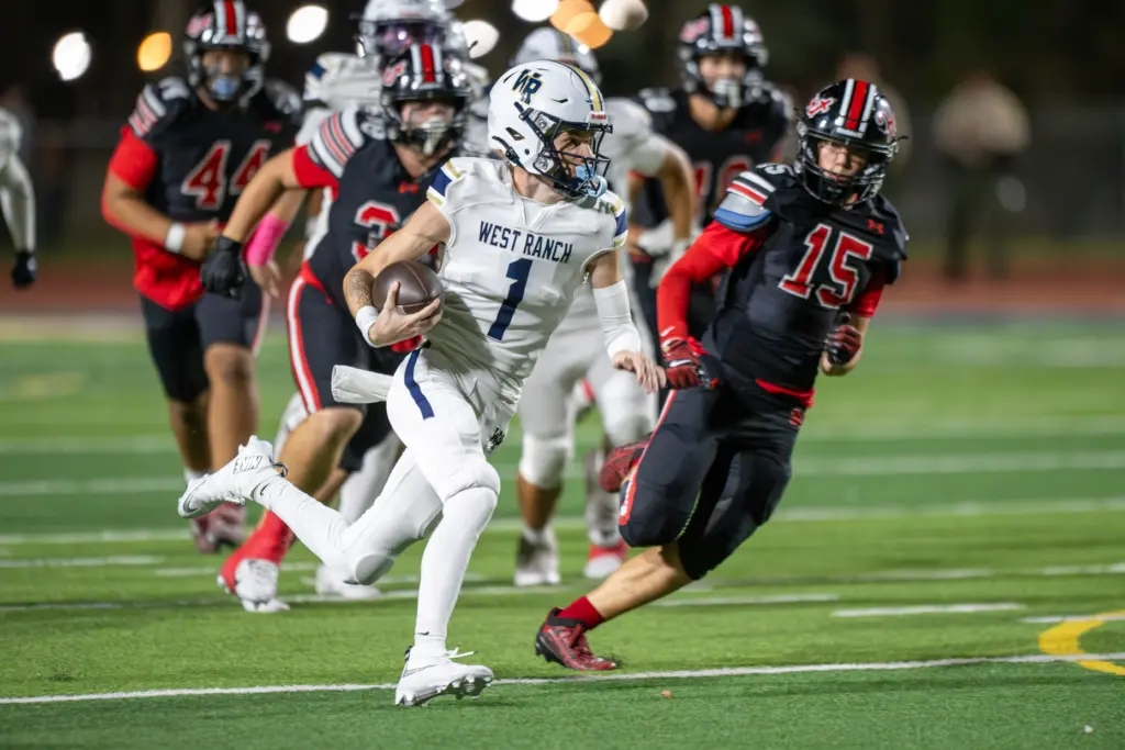 West Ranch High School’s Matthew Steen (1) carries the ball...