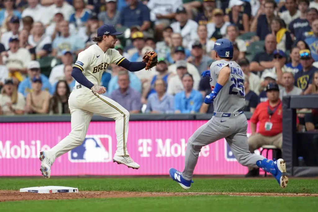 Milwaukee Brewers first baseman Jake Bauers, left, can’t catch an...