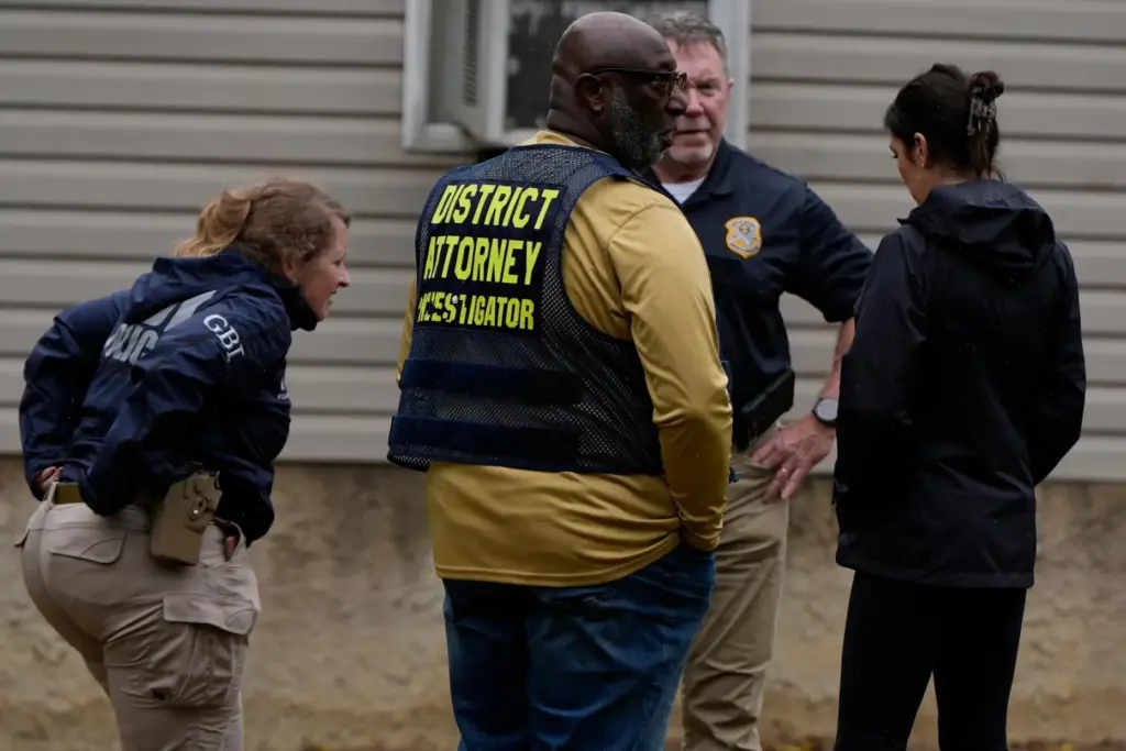 Authorities investigate the scene of a mass shooting in Vienna, Georgia.