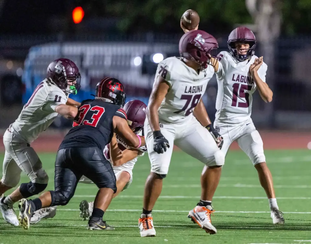 Laguna Beach quarterback Braden Hansen (15) throws the ball during...