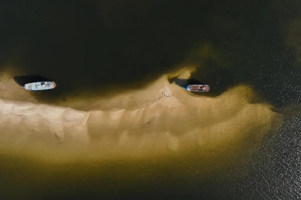 Tourist boats sit idle on sandbanks in the Arapiuns River...