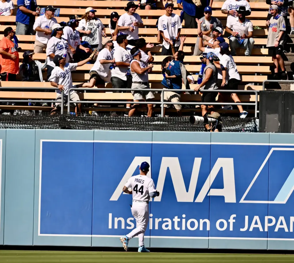 Dodgers center fielder Andy Pages watches as a ball that...