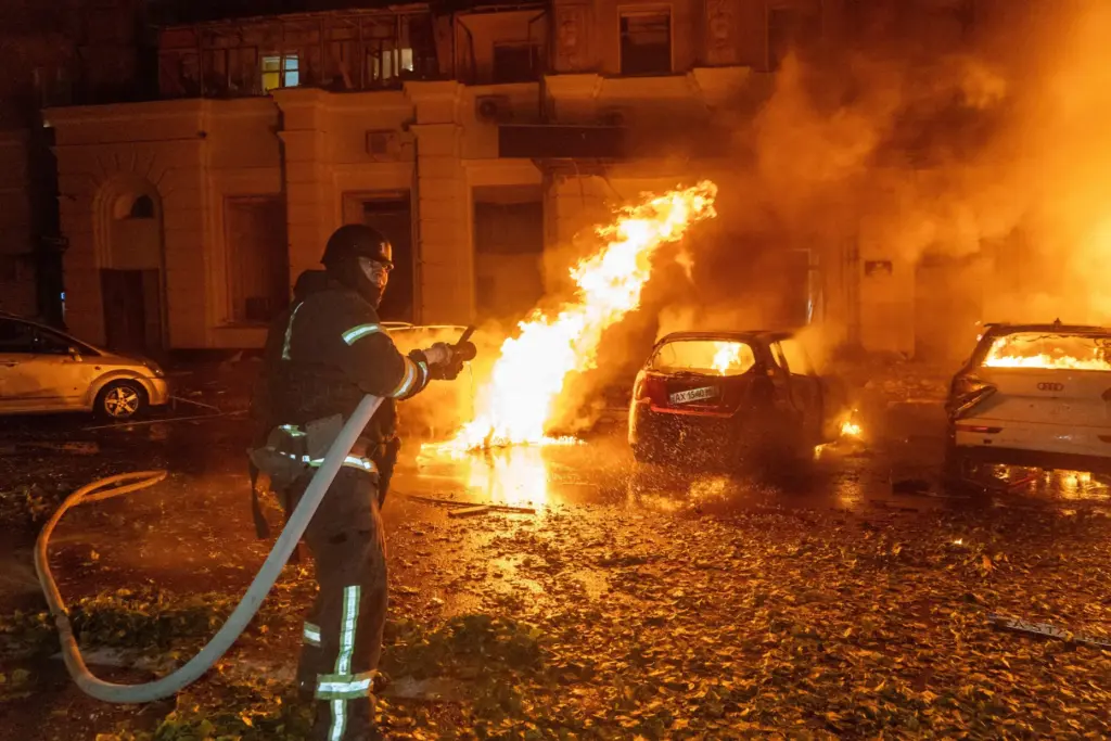 A firefighter puts out a fire following a Russian air attack at a residential building.