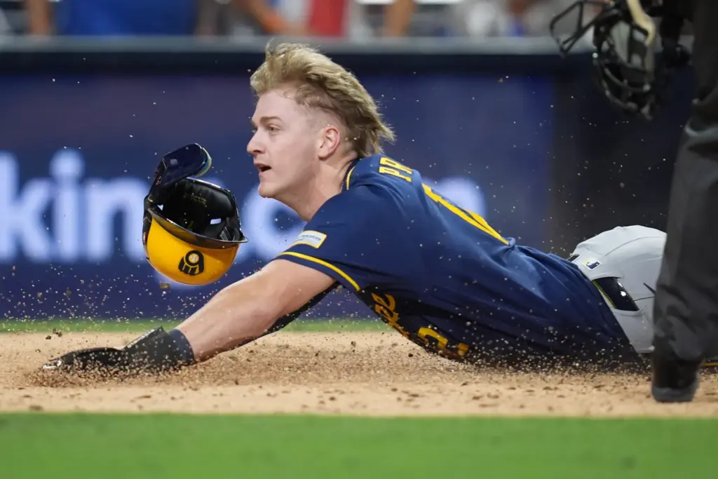 The Milwaukee Brewers’ Cooper Pratt scores during the fifth inning...
