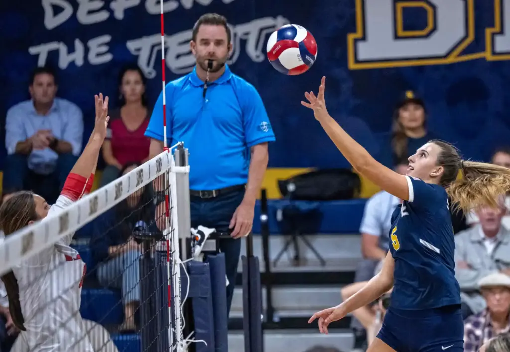 Crean Lutheran opposite hitter Brooke Badorek (5) hits the ball...
