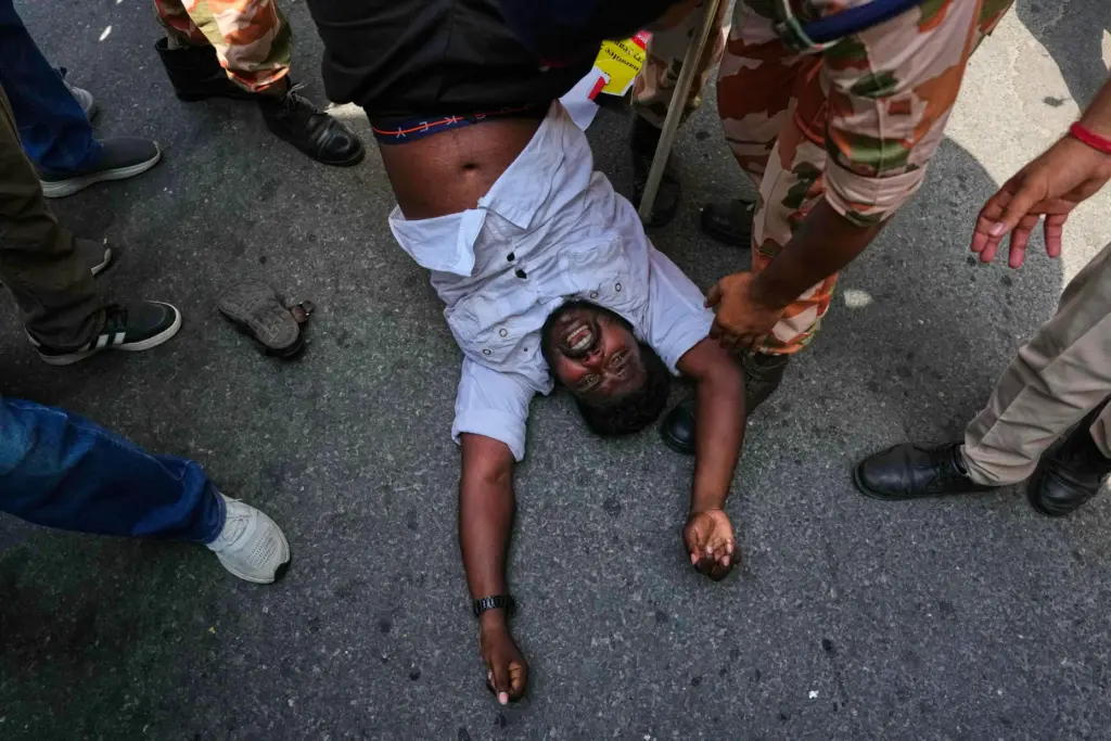 Socialist, left-wing parties and student activists shout slogans as police detain them.