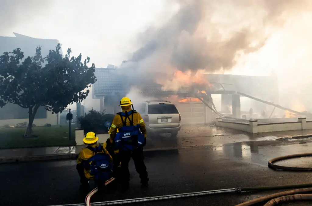 Firefighters work to save structures on Via La Mirada during...