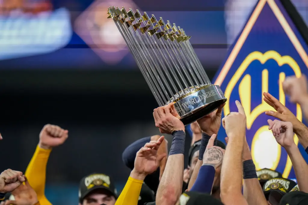 Milwaukee Brewers players hold the World Series trophy after winning...