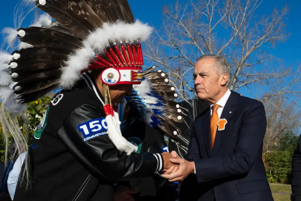 Canada Prime Minister Mark Carney, right, attends the National Day...