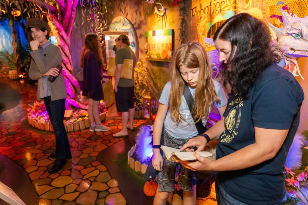 Nava Davis, 12, gets some help searching for interactive story...