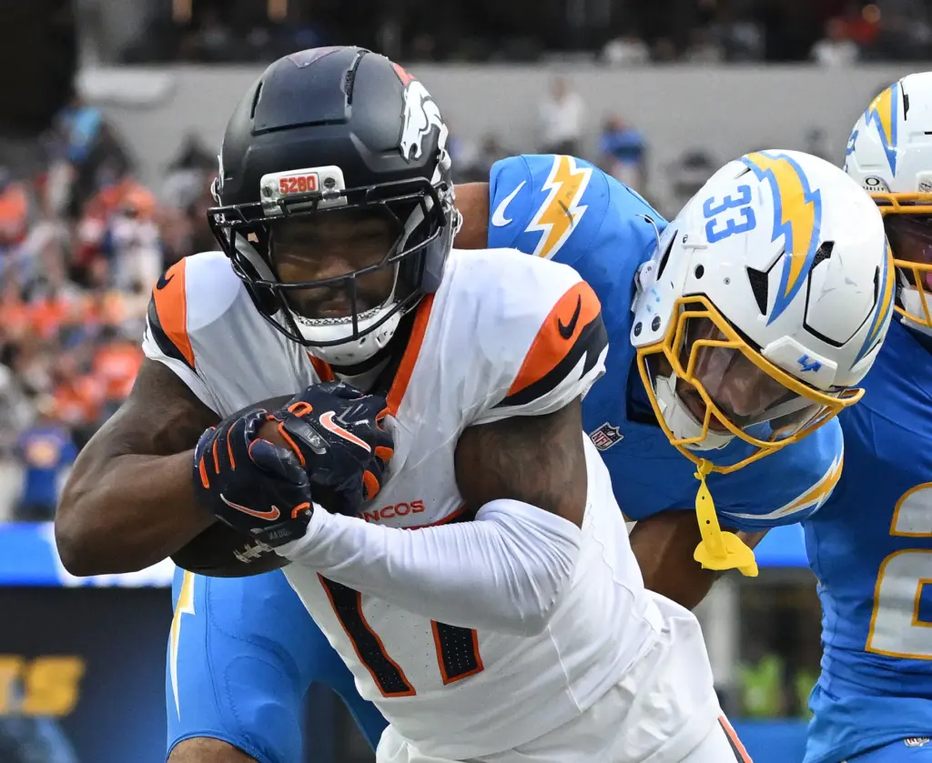 Denver wide receiver Jaylen Waddle (17) is tackled by the...