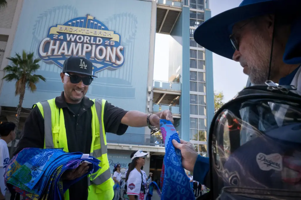 Dodgers fans receive rally towels as they arrive before Game...