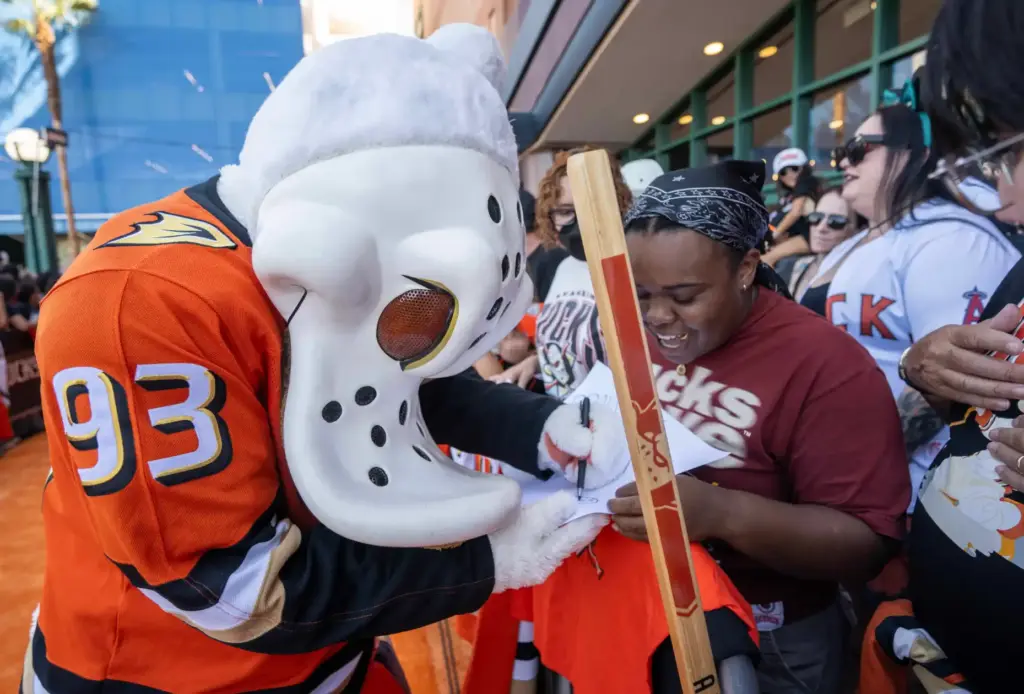 Wild Wing signs autographs for Ducks fans on the orange...