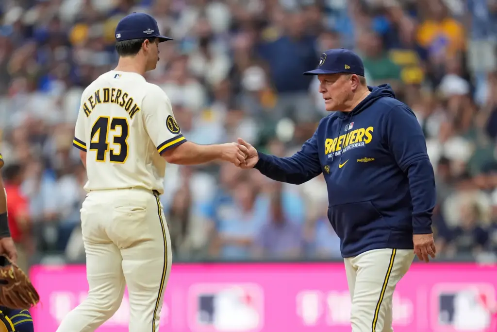Milwaukee Brewers manager Pat Murphy, right, removes starting pitcher Logan...