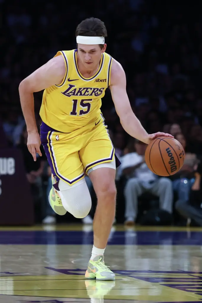 Lakers guard Austin Reaves pushes the ball up the court...