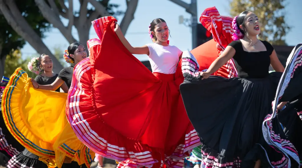 Dancers add color to the Tustin Tiller Days parade on...