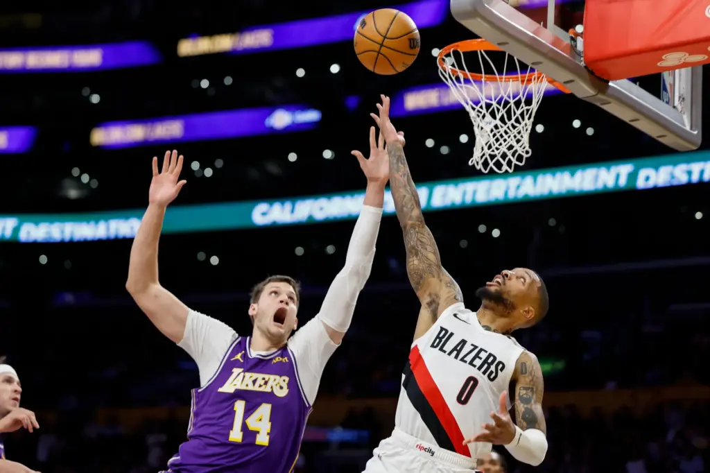 Portland Trail Blazers guard Damian Lillard, right, drives to the...