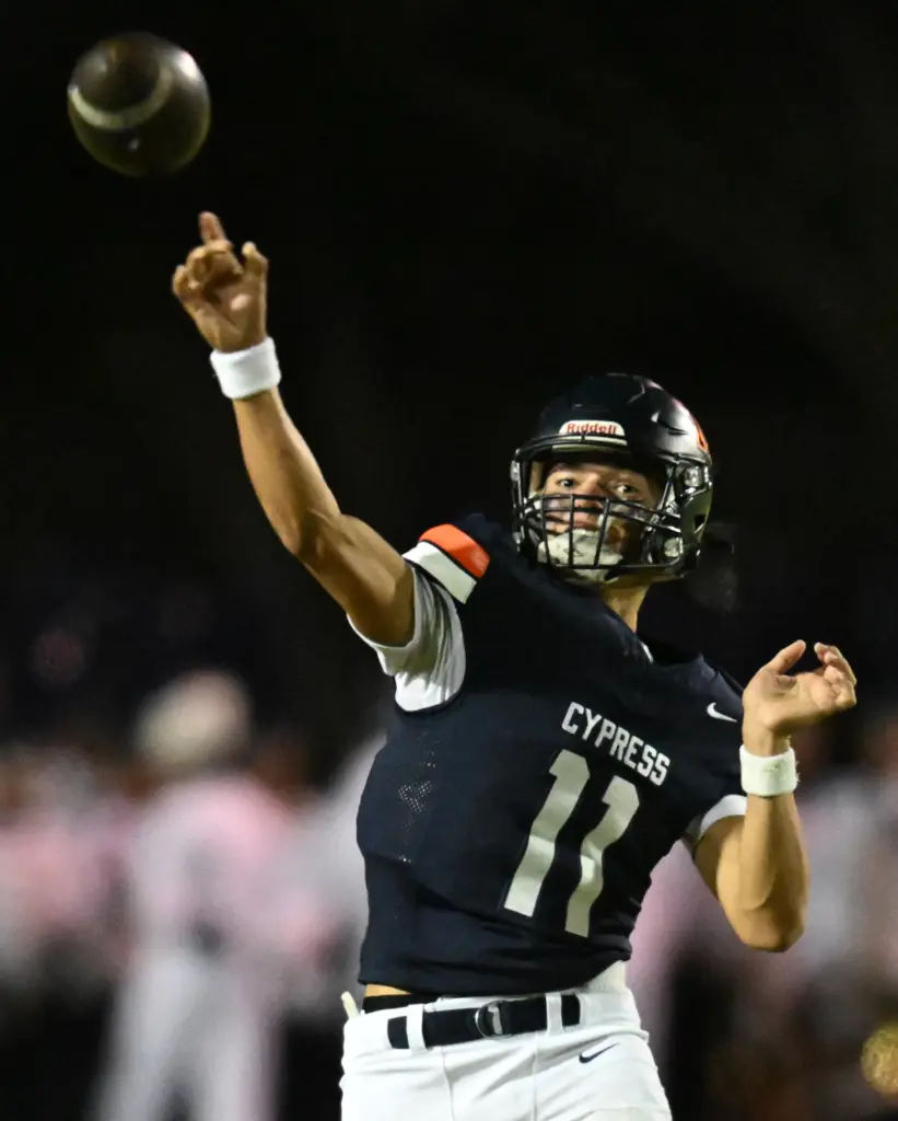 Justin Hall #11 of Cypress throws a pass in the...