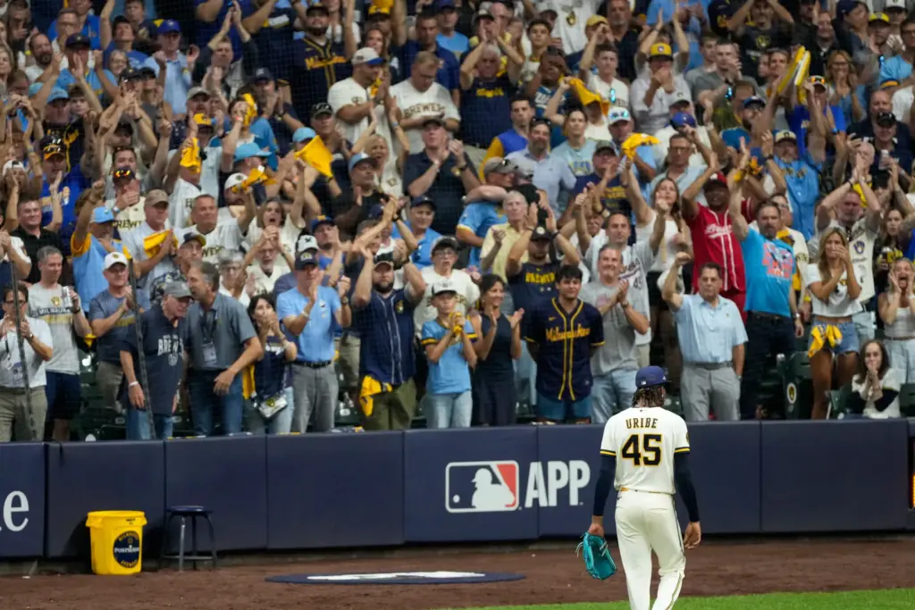 Milwaukee Brewers relief pitcher Abner Uribe is cheered as he...
