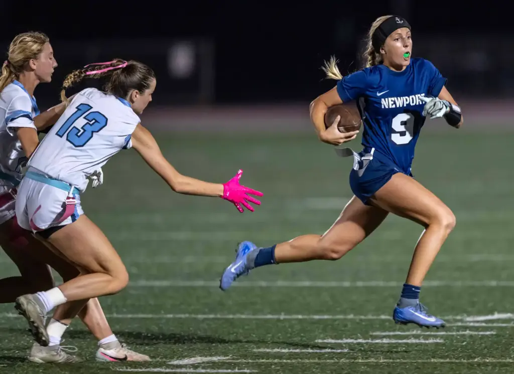 Newport Harbor quarterback Scarlett Guyser (9) carries the ball on...