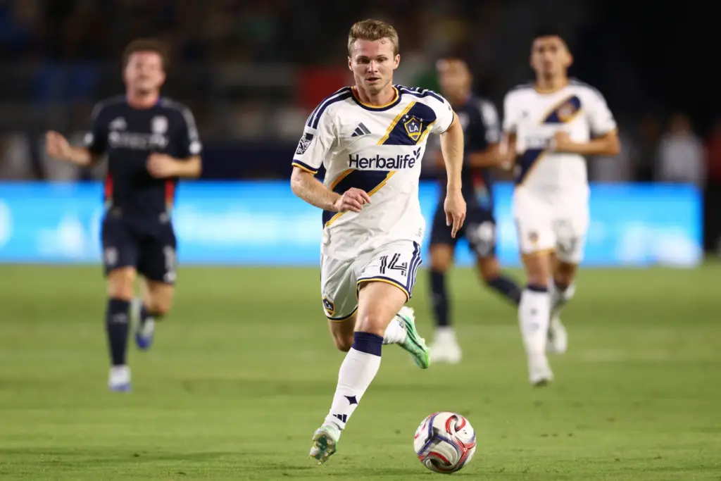 Los Angeles Galaxy defender John Nelson (14) moves the ball...