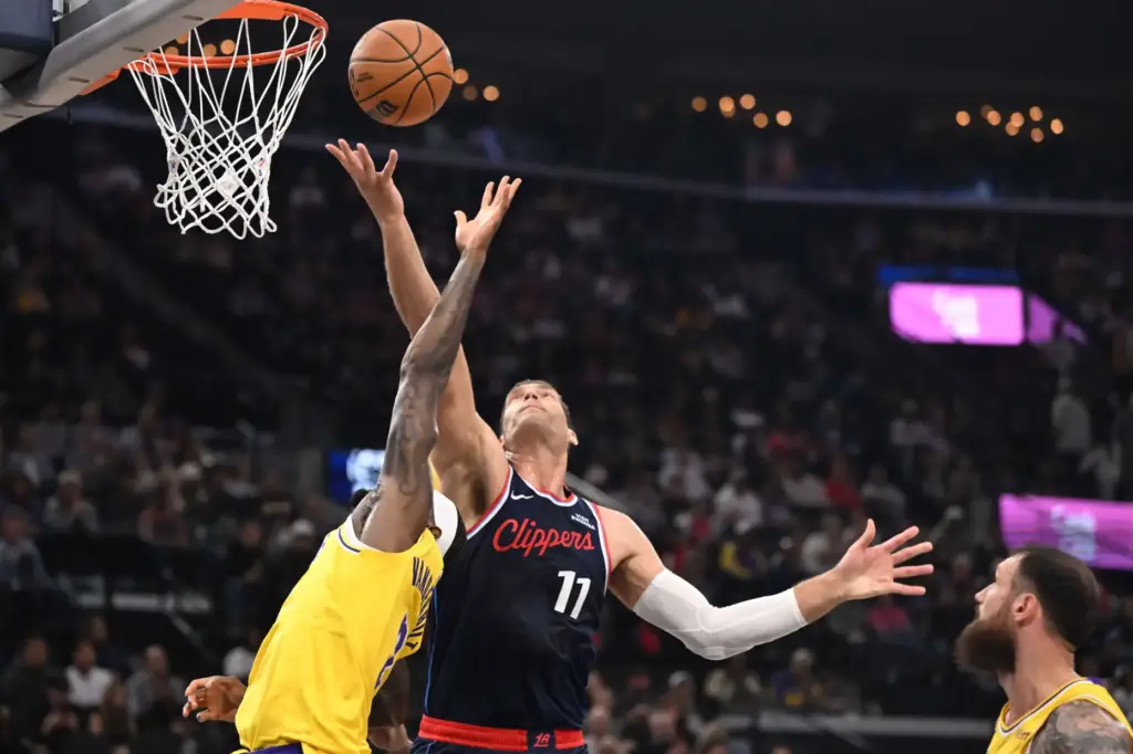Clippers center Brook Lopez (11) reaches for a loose ball...