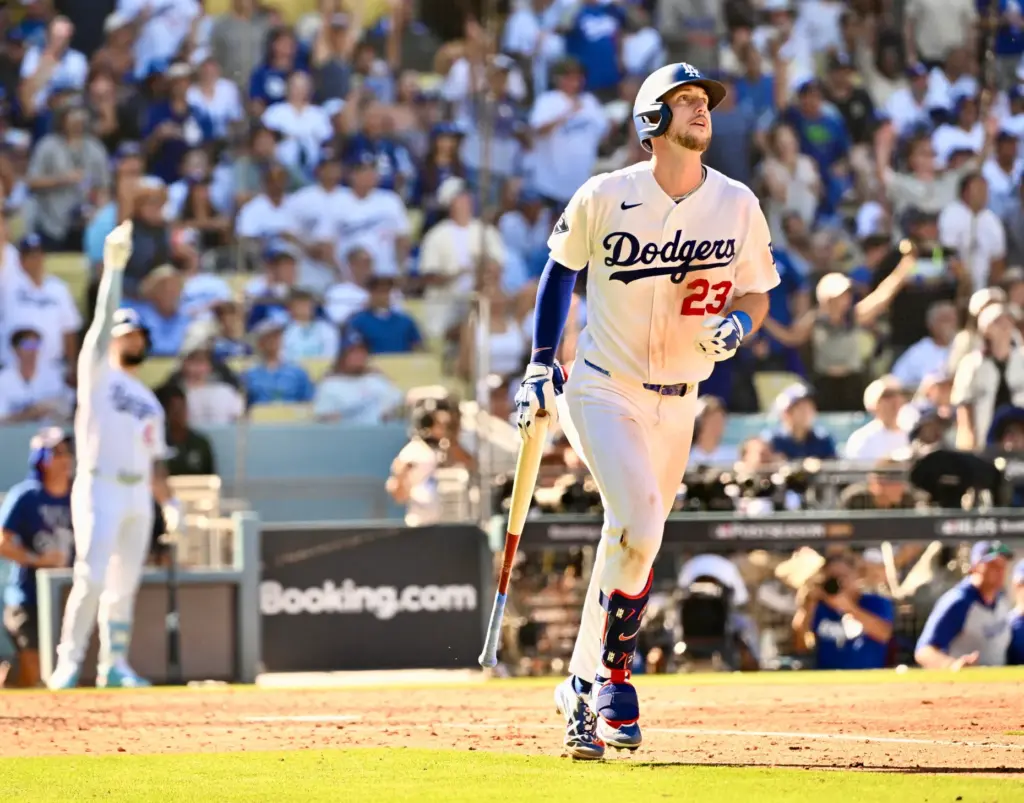 The Dodgers’ Kyle Tucker begins to run the bases as...