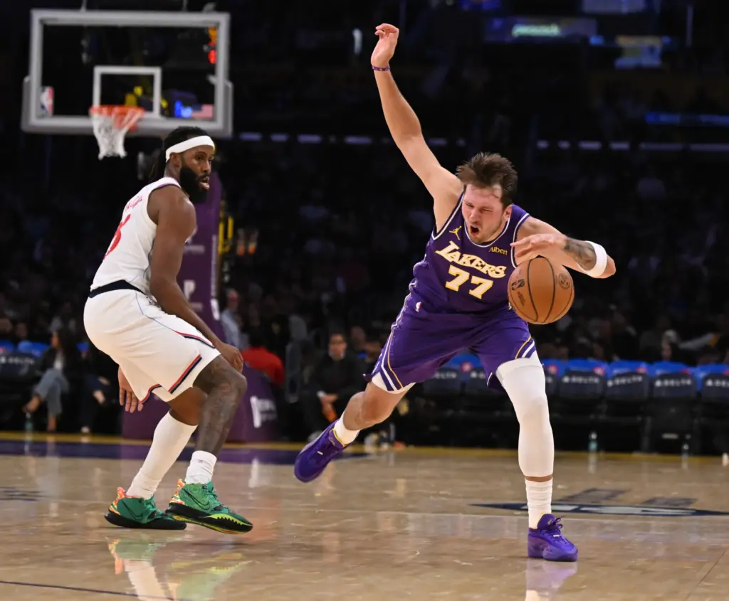 Lakers star Luka Doncic, right, reacts after being fouled by...