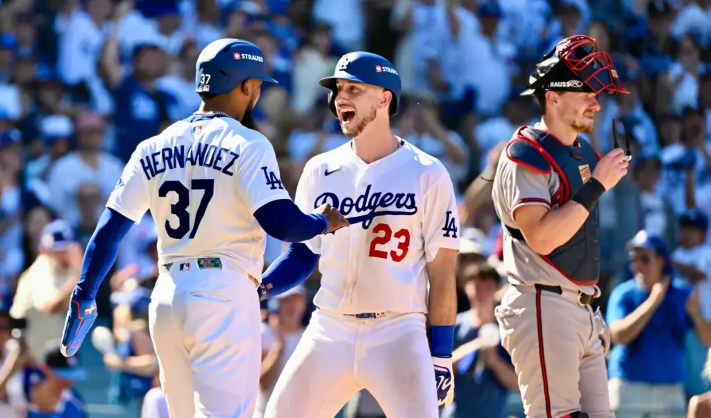 The Dodgers’ Kyle Tucker, center, is greeted by teammate Teoscar...