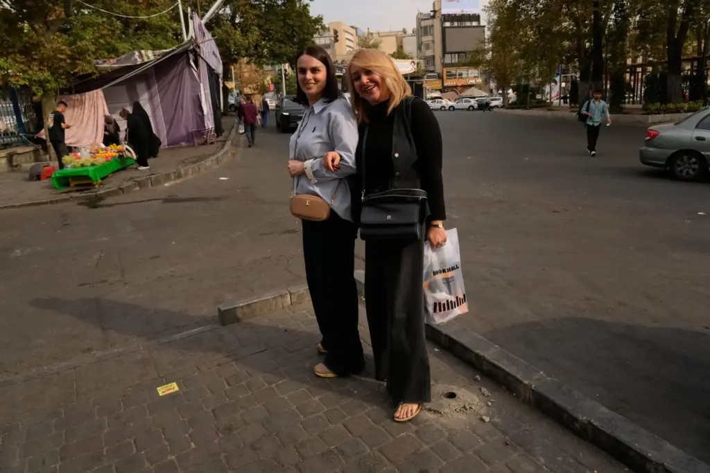 Women pose for a photo in Tajrish Square in Tehran,...
