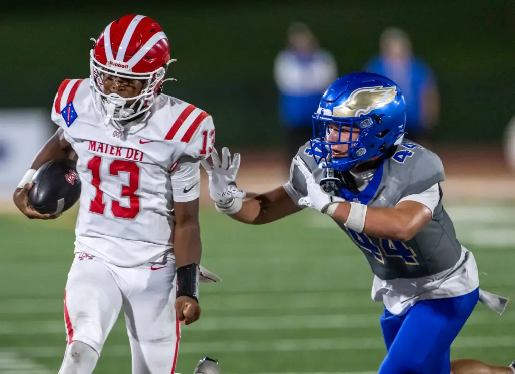 Mater Dei quarterback Paytyn Guess (13) carries the ball on...