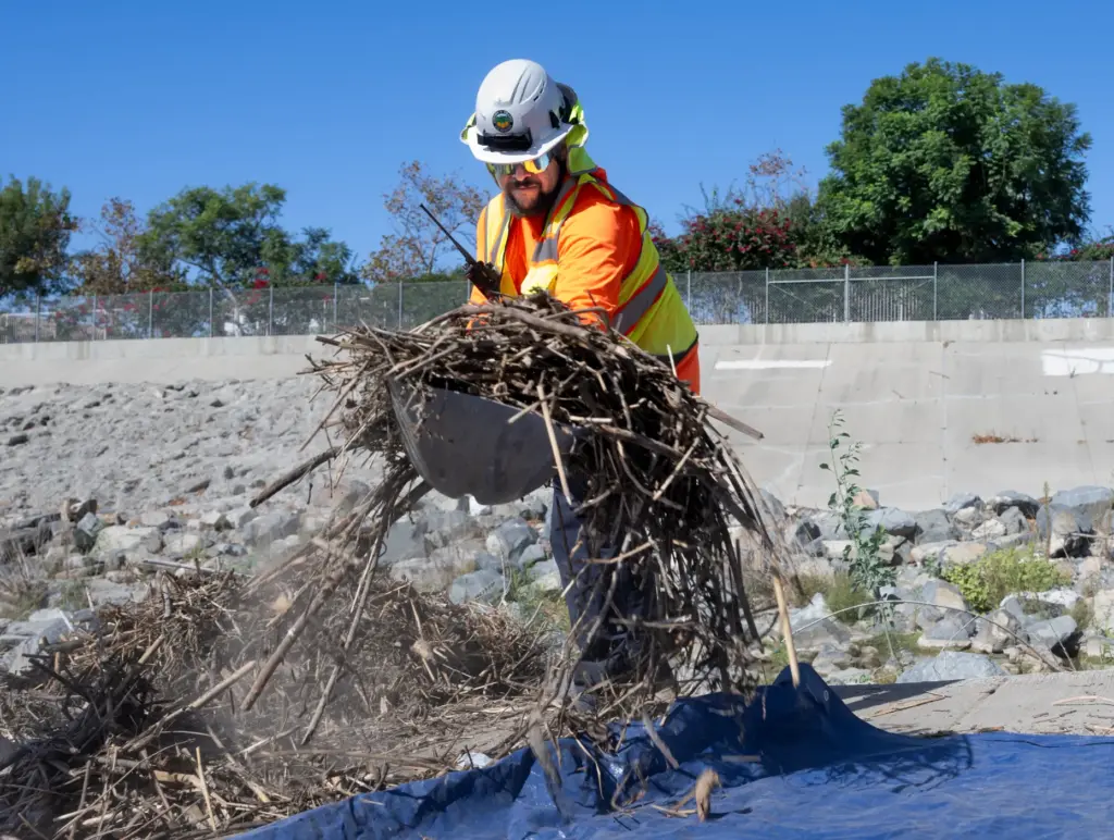 Workers clear the San Juan and Trabuco Creek flood control...