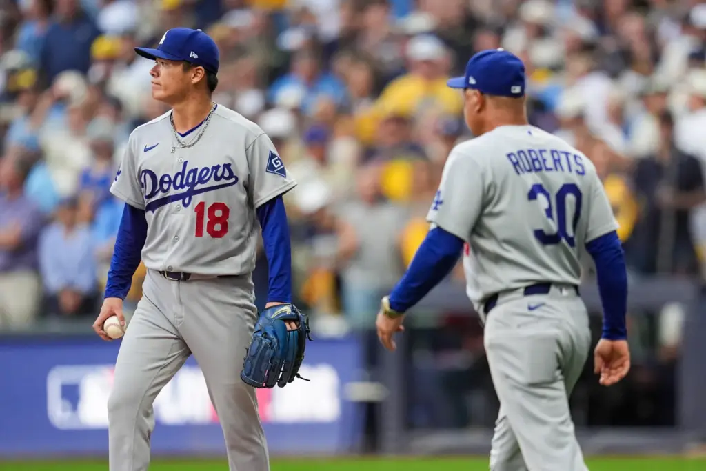 Dodgers manager Dave Roberts, right, arrives at the mound to...